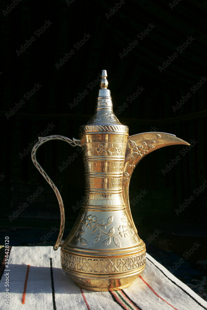 Arabic coffee pot on wood and black background Arabic coffee pot on wood and black background