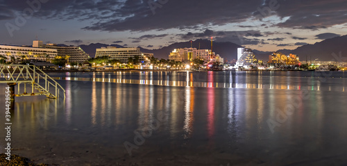 Night on the central public beach in Eilat - famous tourist resort and recreational city in Israel, concept of happy vacation and healthy resting
