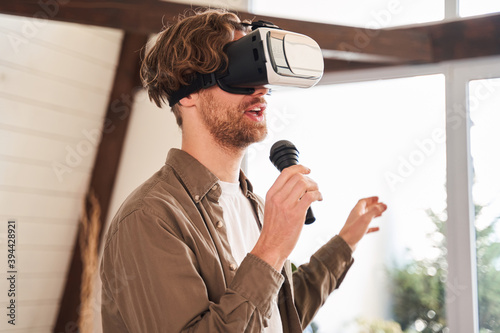 Man wearing glasses of virtual reality singing photo