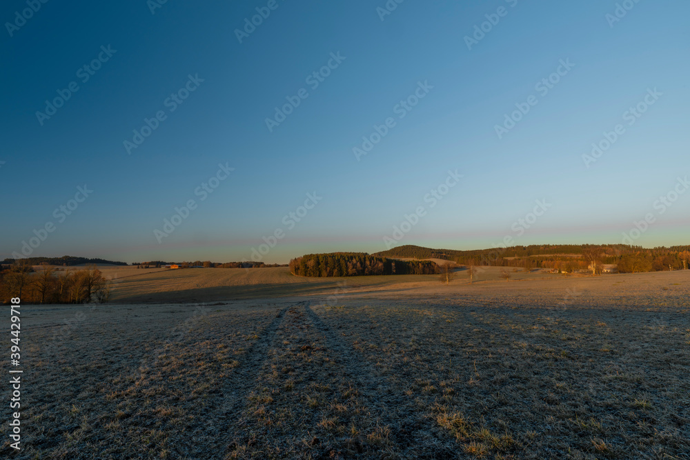 Rybnik village with pasture land in frosty color morning in sunrise time