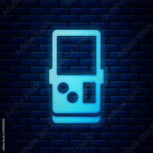 Glowing neon Portable tetris electronic game icon isolated on brick wall background. Vintage style pocket brick game. Interactive playing device. Vector.