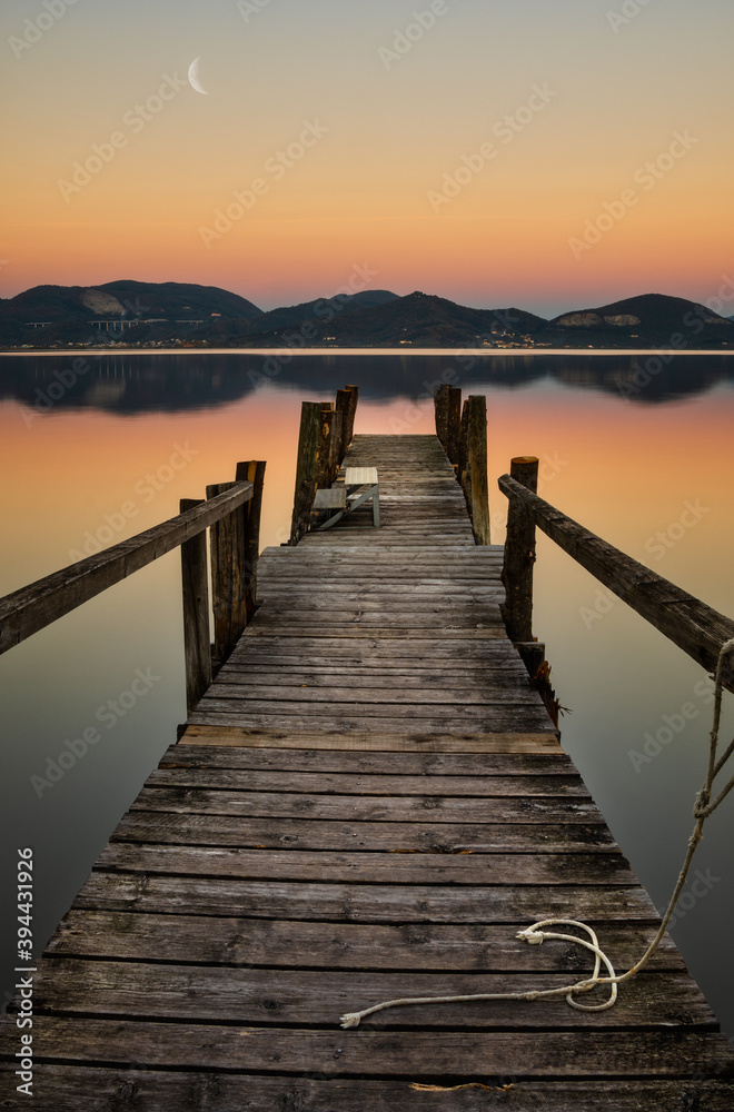 pier at sunset on a tuscany lake