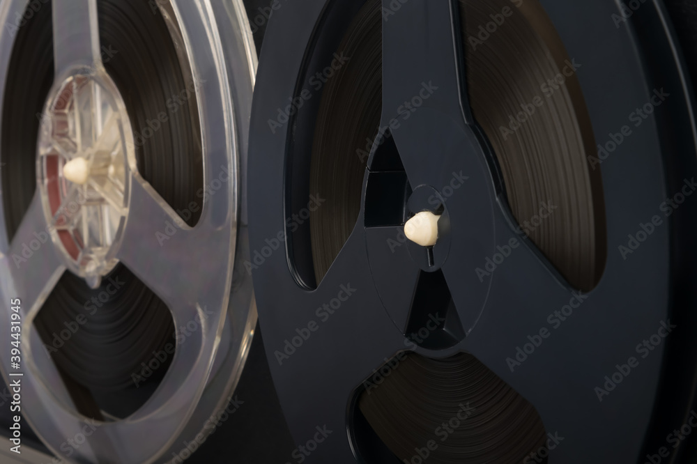 two magnetic tape cassettes, side view, background close-up