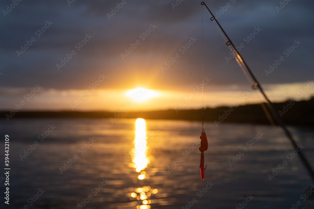 Fishing lure on line above the Naknek River in Alaska during sunrise
