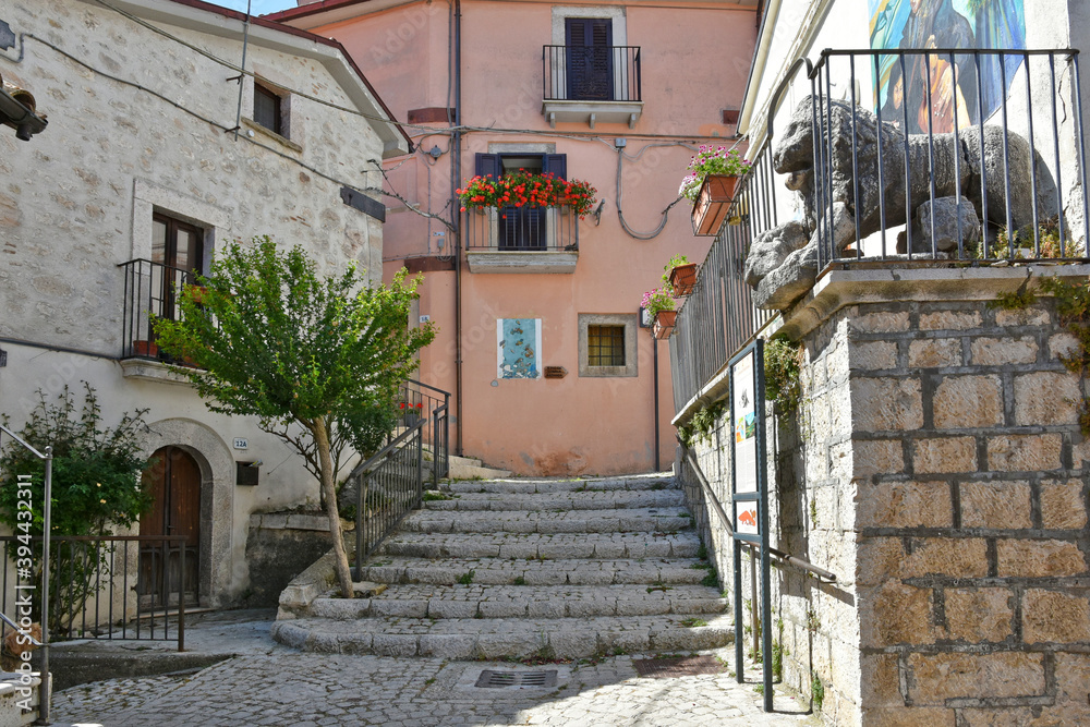 A narrow street among the old houses of Scontrone, a medieval village in the Abruzzo region, Italy.