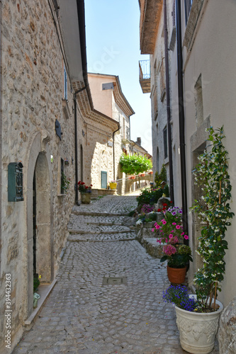 Fototapeta Naklejka Na Ścianę i Meble -  A narrow street among the old houses of Scontrone, a medieval village in the Abruzzo region, Italy.