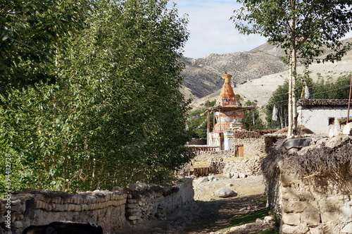 The street leads to the colorful chorten of Buddhist monastery in the Tsarang village. Hiking to the closed zone of Upper Mustang. Nepal. photo