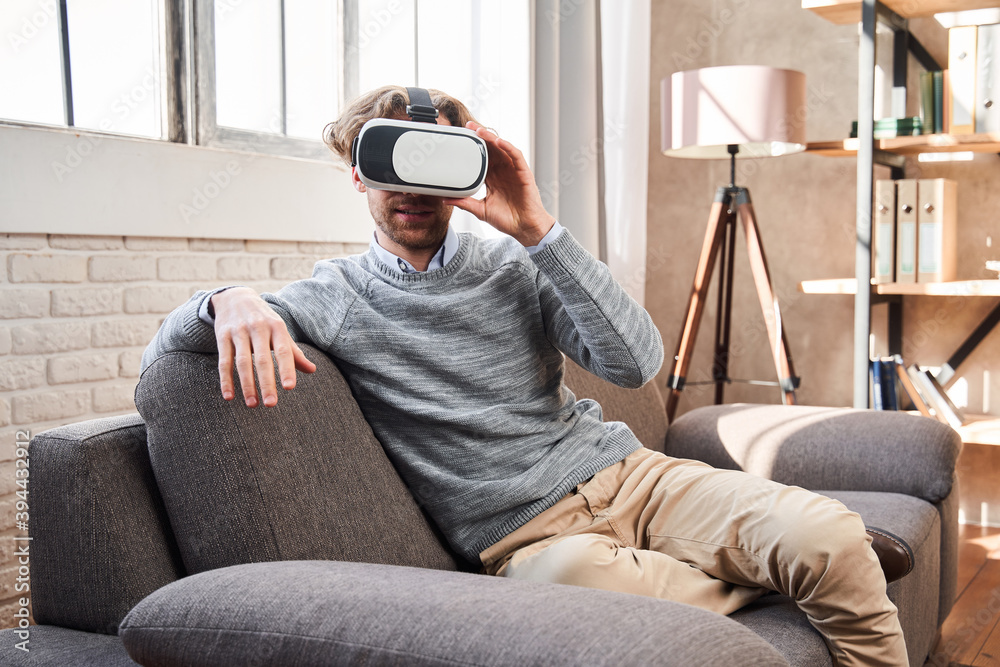 Fototapeta premium Man adjusting his VR headset