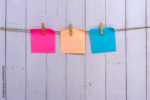 Three colorful paper hang with clothespin on a rope