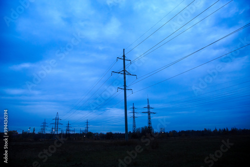 High voltage power line in cloudy twilight