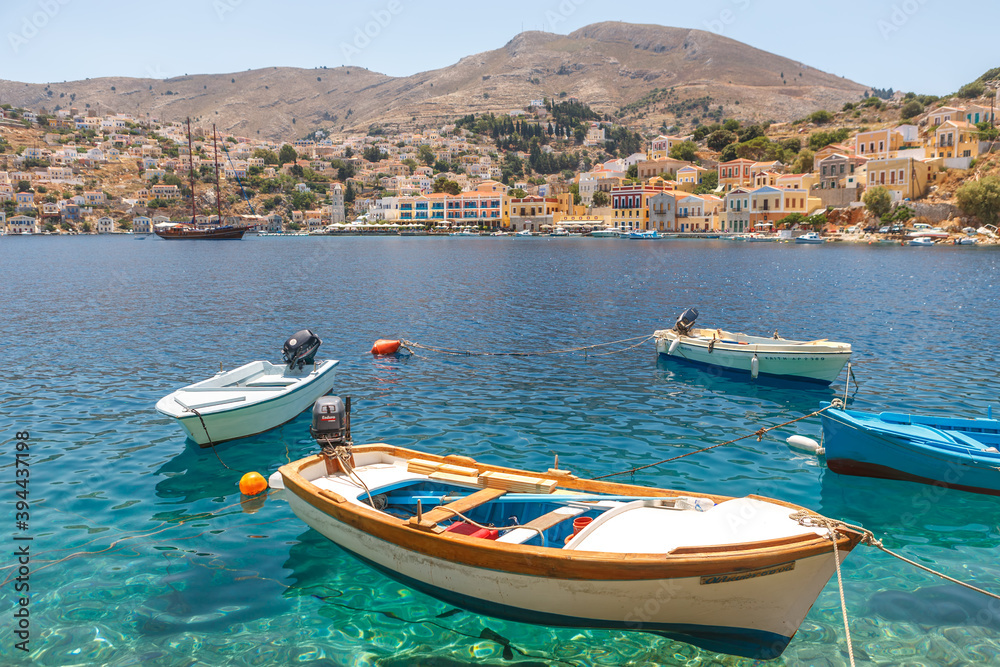 Simi-Greece-July 04, 2011: View of the Bay, beautiful colorful houses and fishing boats of Simi island, Greece