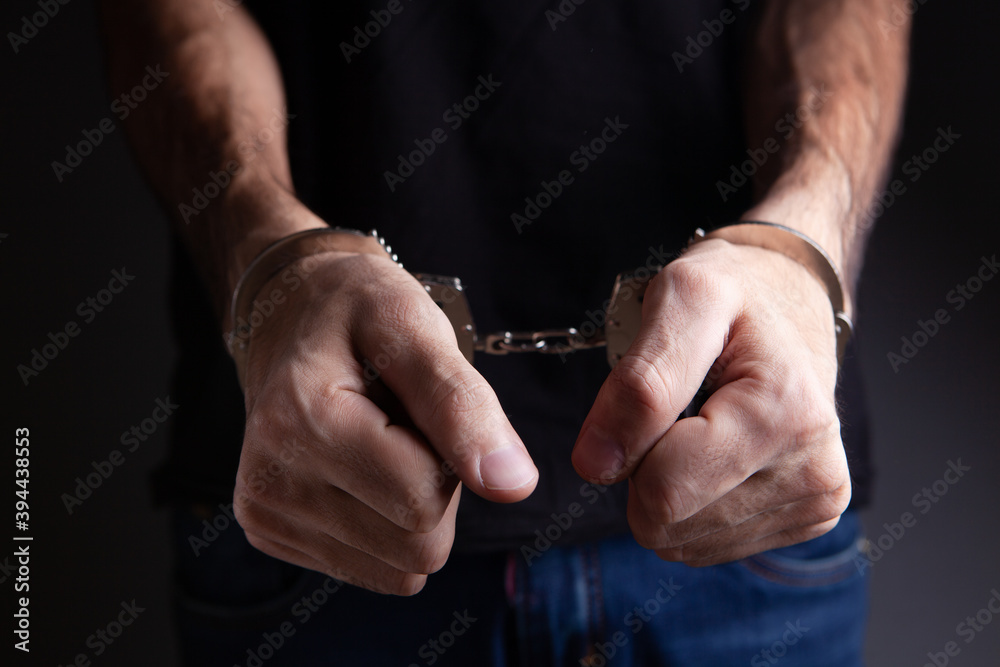Fototapeta premium men handcuffed in criminal concept