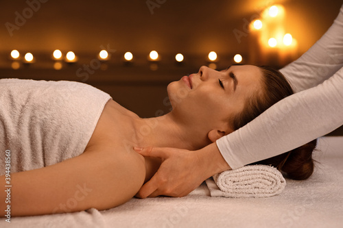 Woman having full body massage session at modern spa