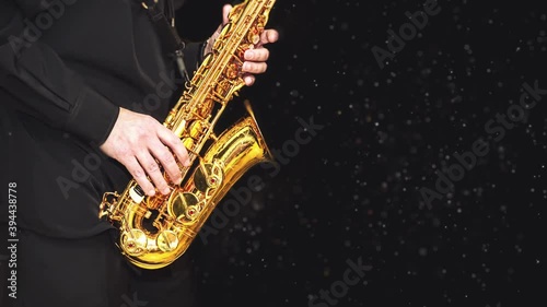 Loop video Saxophone with dust effec Player hands Saxophonist playing jazz music. Alto sax musical instrument closeup on black background