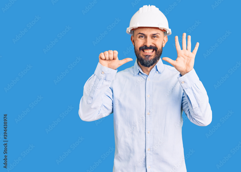 Young handsome man wearing architect hardhat showing and pointing up with fingers number six while smiling confident and happy. Young handsome man wearing architect hardhat showing and pointing up with fingers number six while smiling confident and happy.