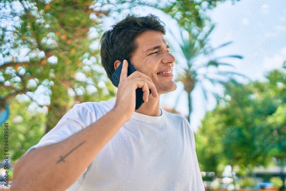 Young caucasian man smiling happy talking on the smartphone at the city. Young caucasian man smiling happy talking on the smartphone at the city.
