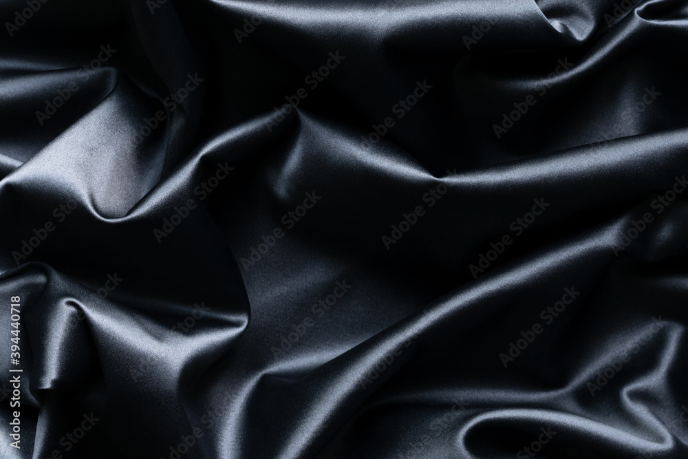 Fototapeta premium Abstract dark blue silk background and texture with folds.