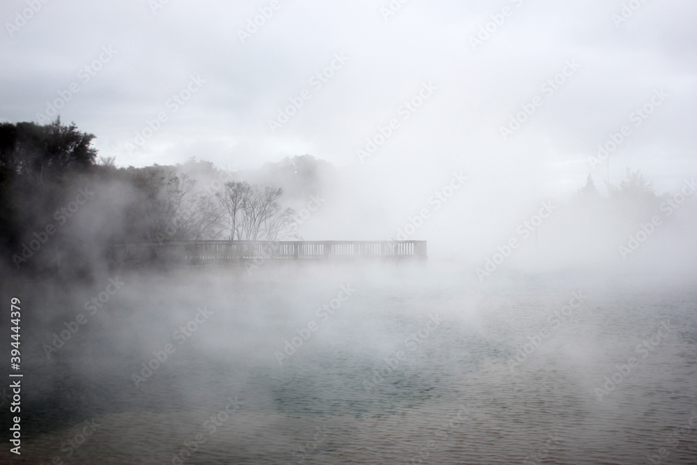 fog flowing over the water with a wooden pier in the background fog flowing over the water with a wooden pier in the background