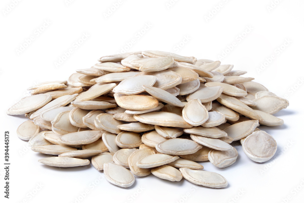 Raw dried pumpkin seeds isolated on white. Heap of pumpkin seeds Raw dried pumpkin seeds isolated on white. Heap of pumpkin seeds