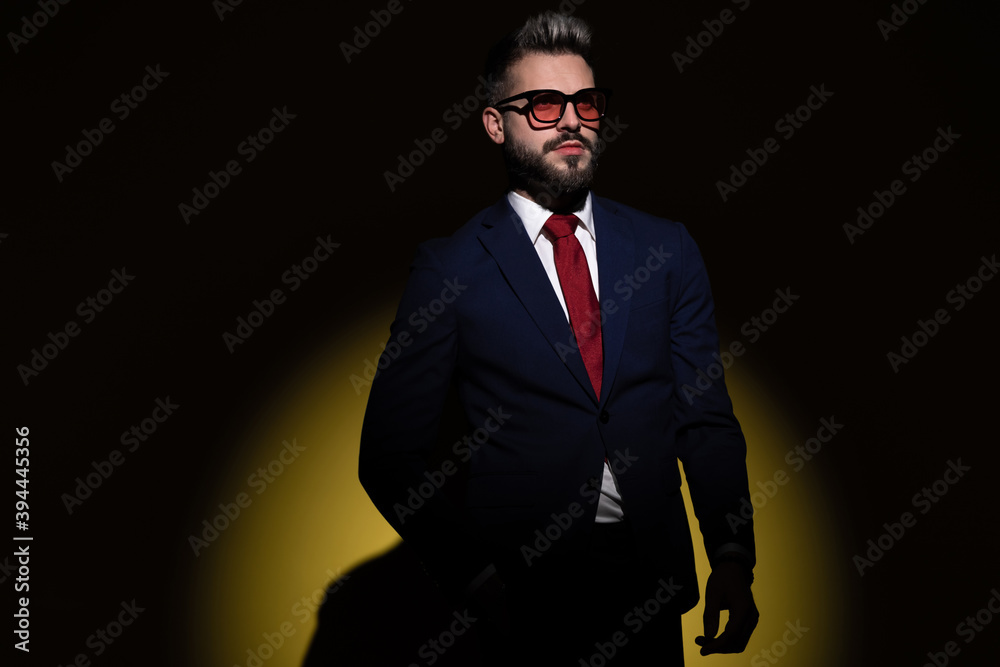 mysterious young guy in suit holding hand in pockets mysterious young guy in suit holding hand in pockets