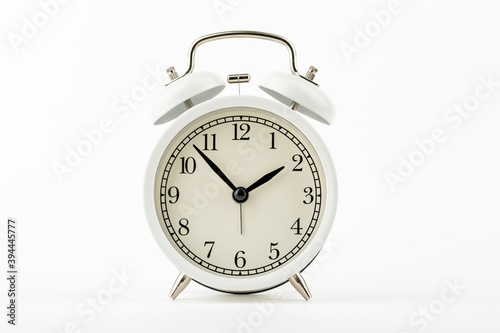 beige vintage alarm clock on white background