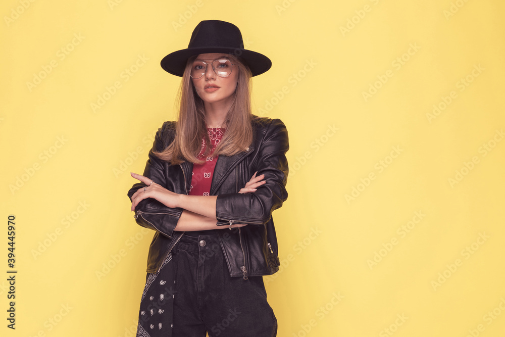 young casual woman crossing her arms, wearing a black hat young casual woman crossing her arms, wearing a black hat