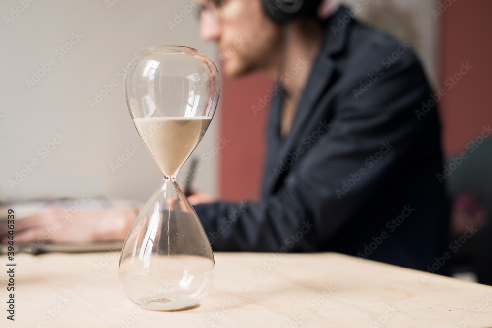 Hourglass, man working on background, Sweden