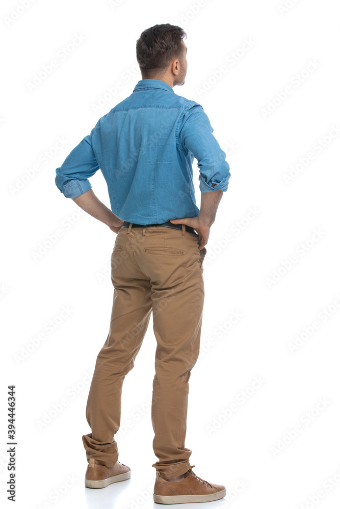 casual man standing with his hands on his hips casual man standing with his hands on his hips