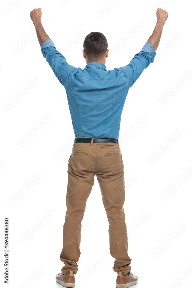 excited casual man celebrating succes with his arms up excited casual man celebrating succes with his arms up