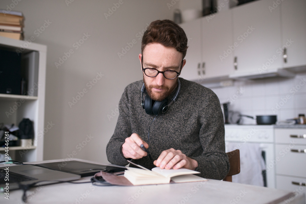Man writing notes in diary, Sweden Man writing notes in diary, Sweden