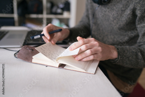 Man writing notes in diary, Sweden photo