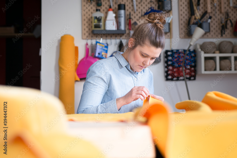 Woman sewing in workshop, Sweden Woman sewing in workshop, Sweden