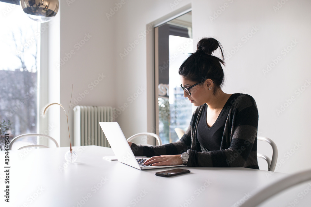 Woman in office using laptop, Sweden