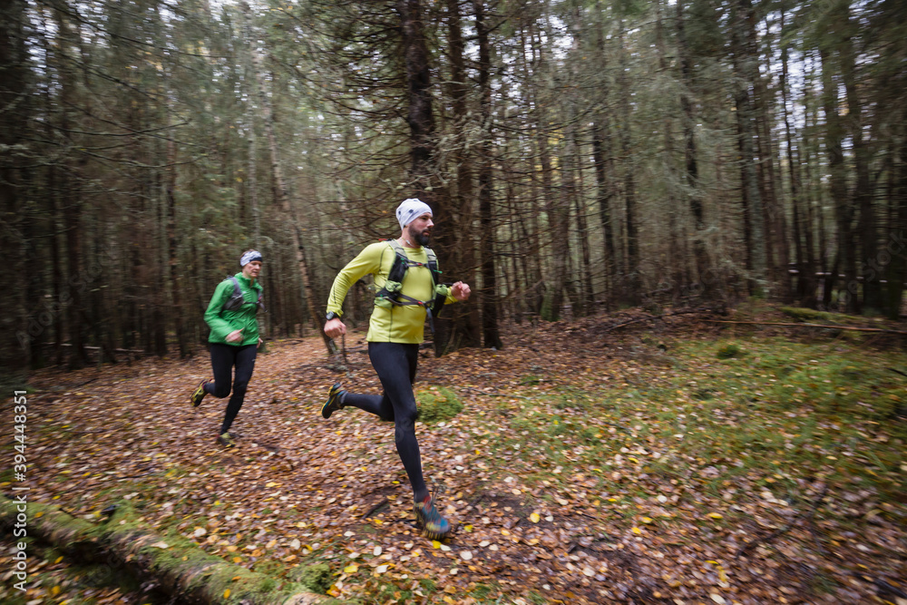 Man and woman running in forest, Sweden Man and woman running in forest, Sweden