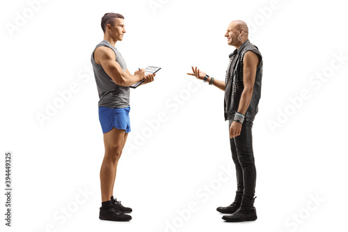 Full length profile shot of a punk man talking to a male fitness trainer