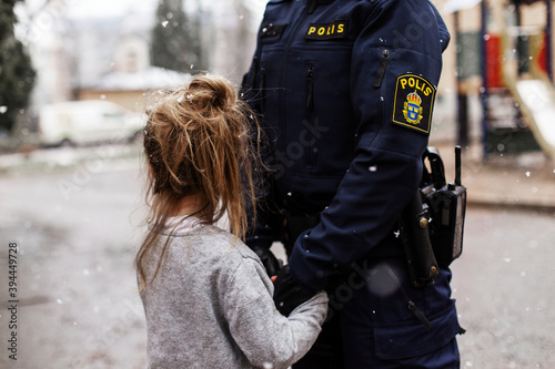 Police woman hugging daughter, Sweden photo