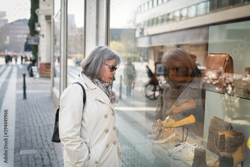 Woman looking in shop window, Sweden photo