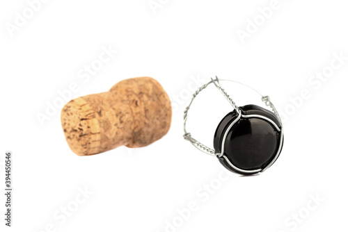 Selective focus. Separated champagne cork and wire isolated on white background.