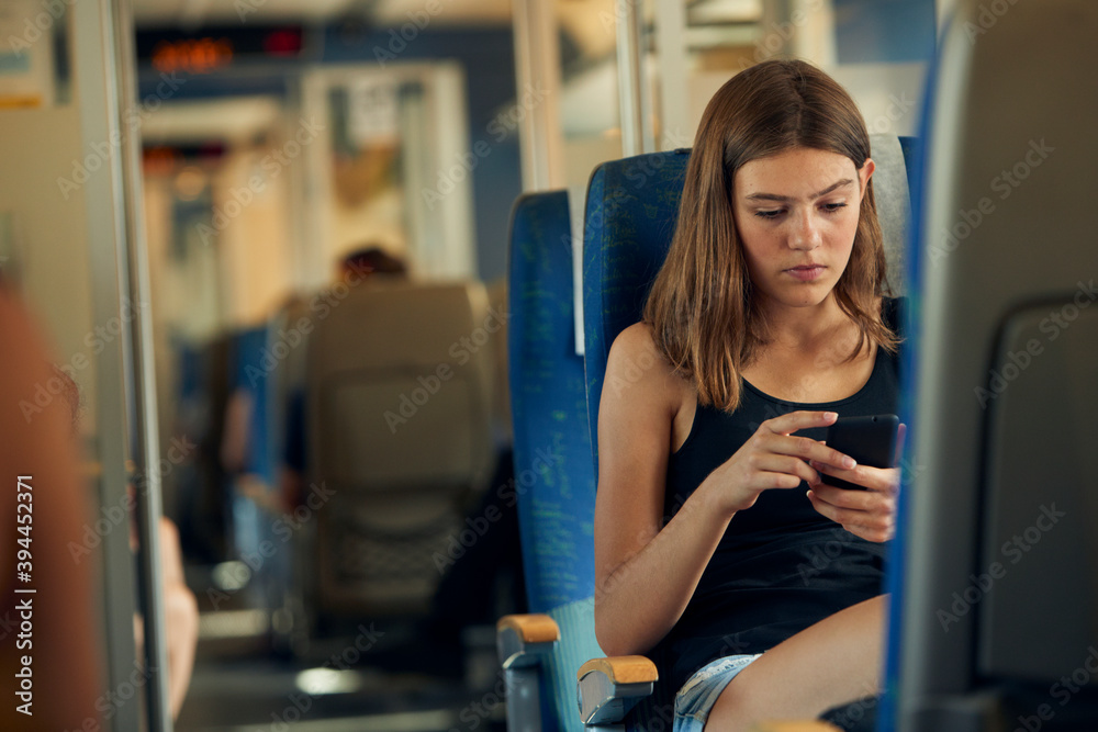 Woman using phone in train, Sweden Woman using phone in train, Sweden