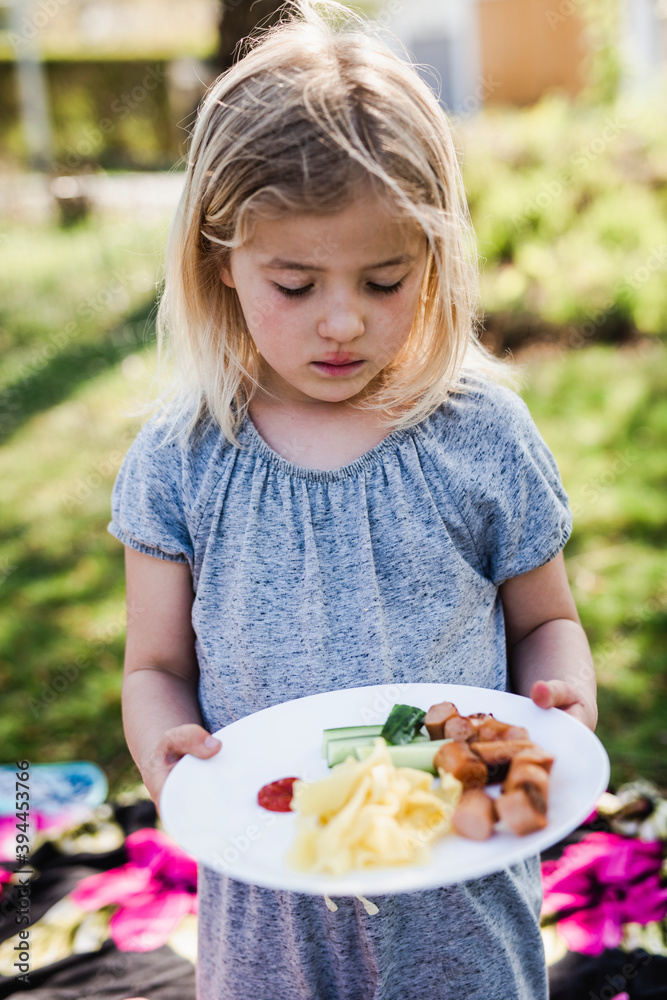 Girl looking at food on her plate, Sweden Girl looking at food on her plate, Sweden