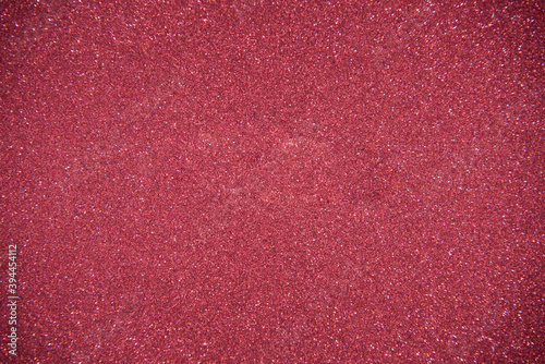 Glitter red background. Photo of monotone shiny background.