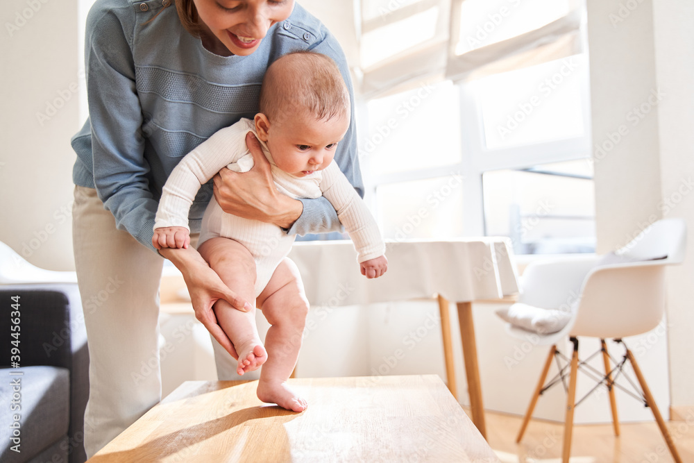 Fototapeta premium Mom teaching her son to walk