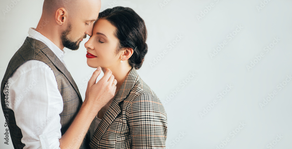 Beloved couple. Love affection. Family look. Enjoying moments. Happy sensual man and woman embracing together isolated on white copy space side view.