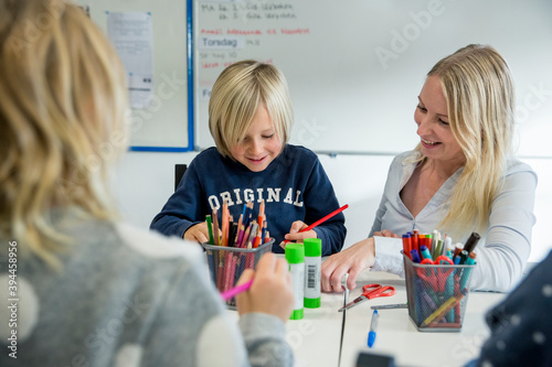 Wallpaper Mural Teacher helping boy in classroom, Portugal Torontodigital.ca