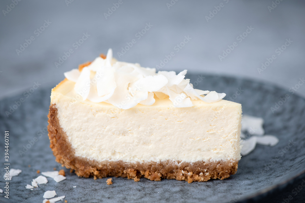 Slice of vegan coconut cheesecake on a plate. Coconut cashew cheesecake