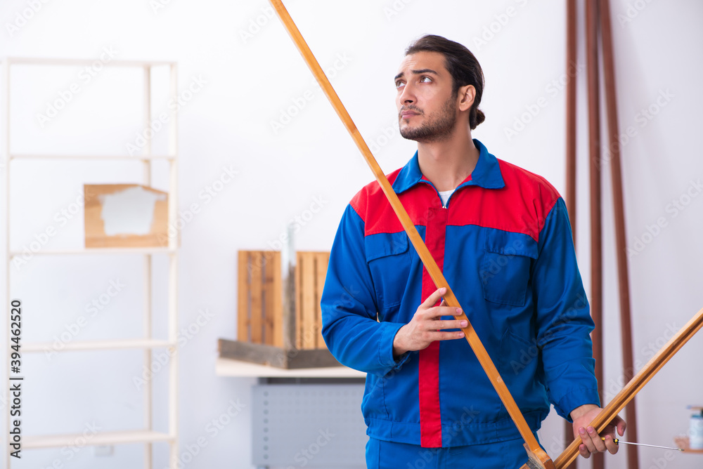Young male contractor working in workshop Young male contractor working in workshop