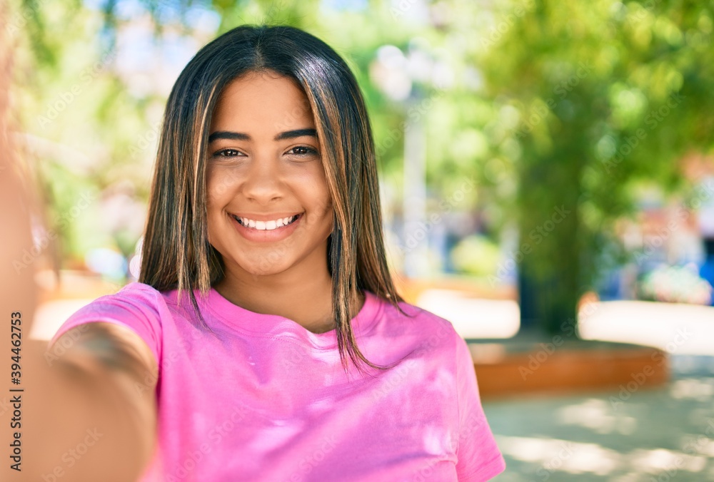 Young latin woman smiling happy making selfie by the camera at the park. Young latin woman smiling happy making selfie by the camera at the park.