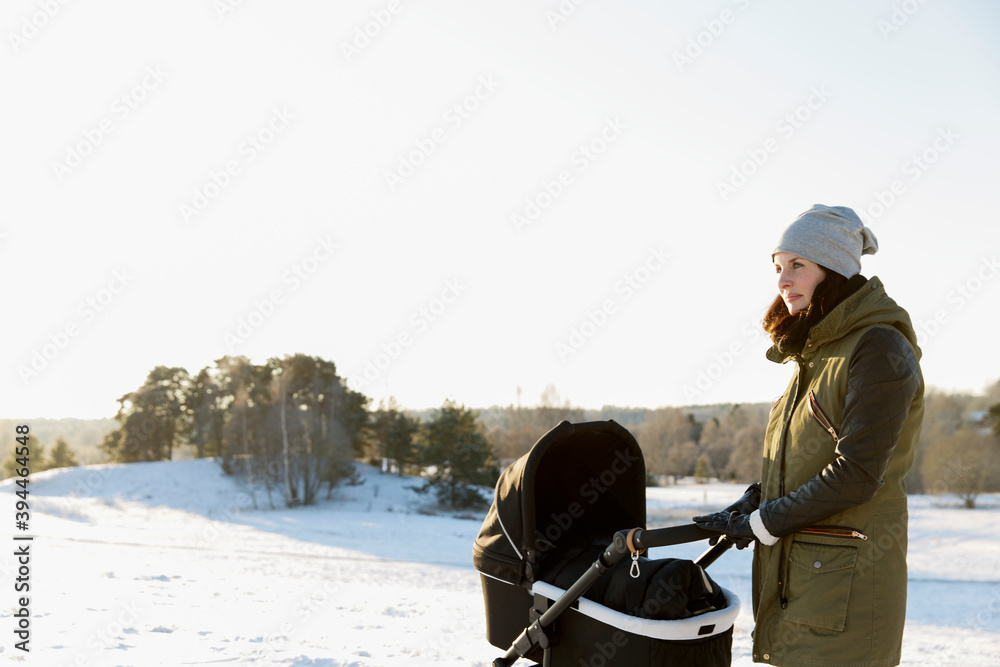 Woman with pram at winter, Sweden Woman with pram at winter, Sweden