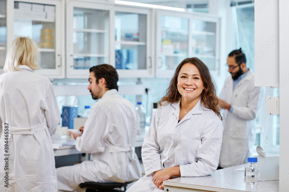 Smiling woman in laboratory, Sweden Smiling woman in laboratory, Sweden