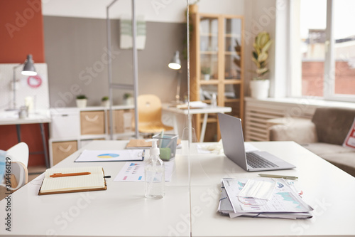 Background image of two office desks separated by glass pane at post pandemic workplace  copy space